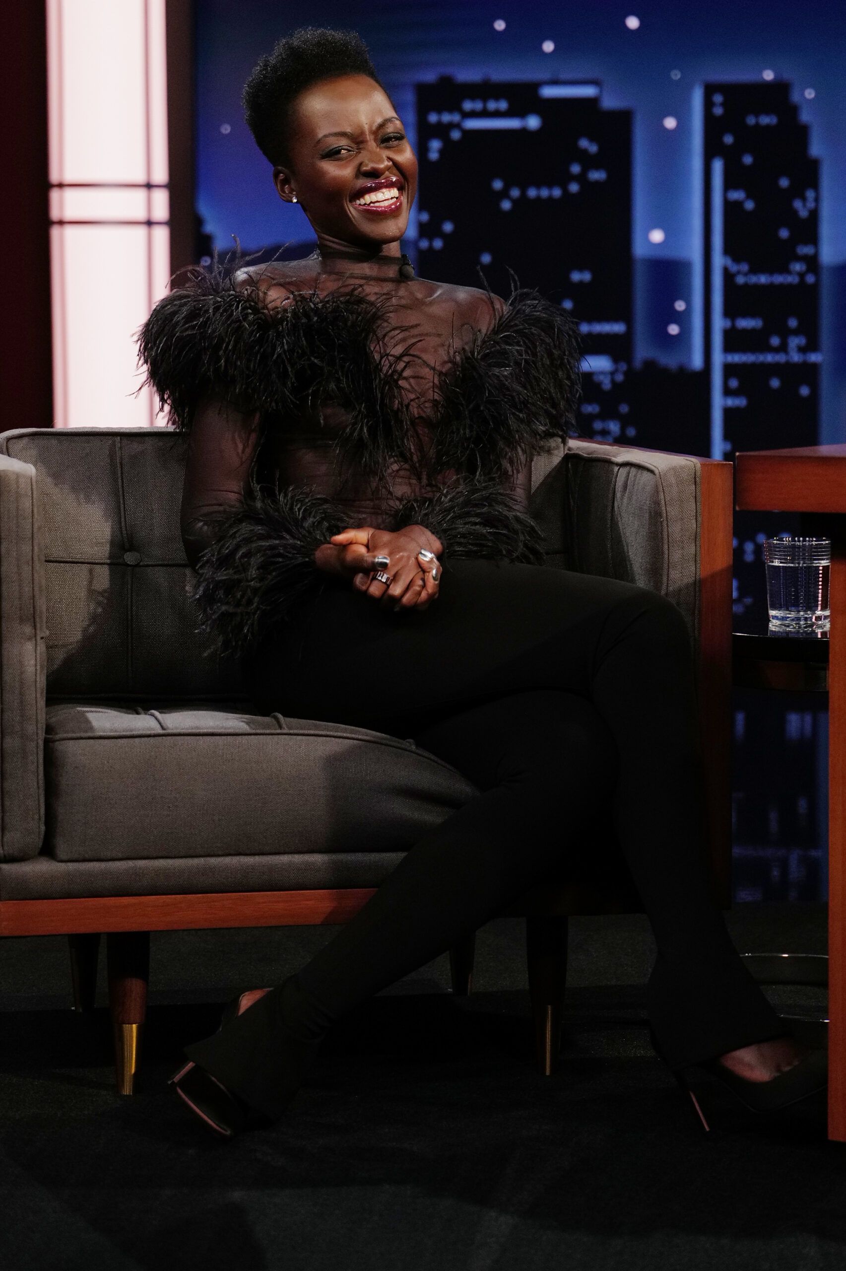 Wardrobe Breakdown: Lupita Nyong’o Black Feather Bodysuit On Jimmy Kimmel